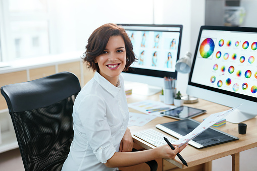 Woman Designer Working On Computer In Office. Female Working On Web Design Project With Illustrations. High Resolution